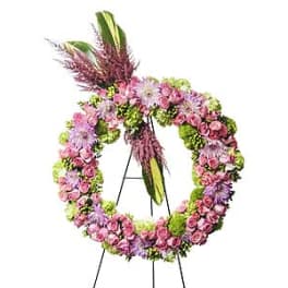 Pink and purple floral wreath on a black easel