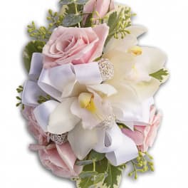 Pink roses and white orchids with a white ribbon bow