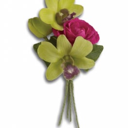 Boutonniere with green orchids and a pink rose