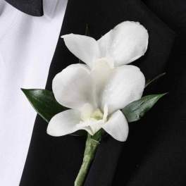 White orchid boutonniere on a black suit jacket