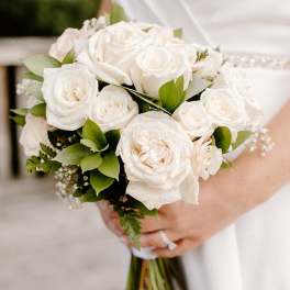 White rose bridal bouquet with green foliage