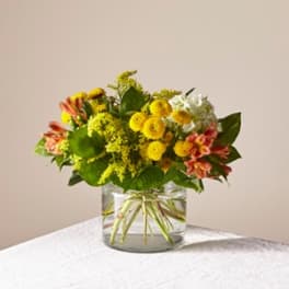 Yellow and pink mixed bouquet in a clear glass vase