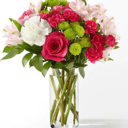 Bouquet of pink and white flowers in a clear glass vase