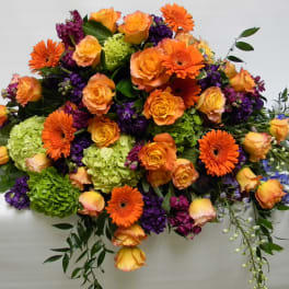 Large bouquet of orange roses, gerbera daisies, and purple flowers