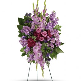 Tall purple floral standing spray on a wire easel