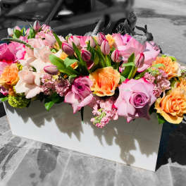 Large pink and peach rose arrangement in a white box
