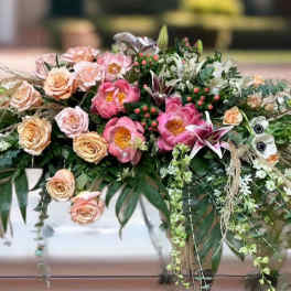 Large floral arrangement with pink and peach roses and lilies