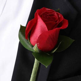 Red rose boutonniere on a black suit jacket