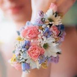 Pastel floral wrist corsage with pink, blue, and white blooms