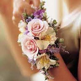 Small wrist corsage with pink roses and purple flowers