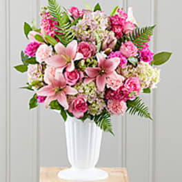 Pink and white floral arrangement in a white vase
