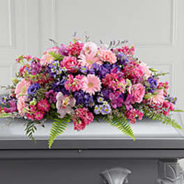 Large pink, purple, and white floral casket spray