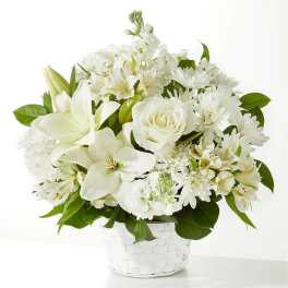 White floral arrangement in a white woven basket vase