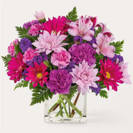 Pink and purple mixed bouquet in a clear glass vase