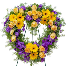 Heart with bright purple and yellow seasonal flowers