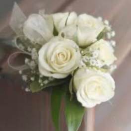 White rose bouquet with small filler flowers and ribbon wrap