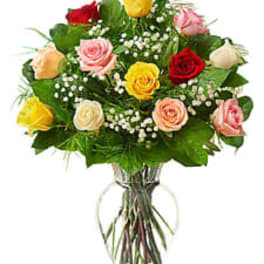 Bouquet of multicolored roses in a clear glass vase