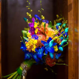 Bright multicolored bouquet with blue, purple, yellow, and peach flowers