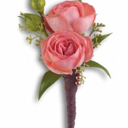 Pink rose boutonniere with green accents and wrapped stem