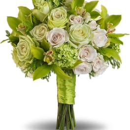 Green and white bouquet of roses and orchids with a satin-wrapped handle