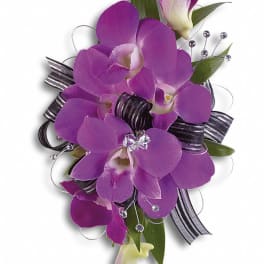 Purple orchid corsage with black ribbon and rhinestone accents