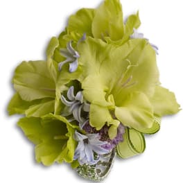 Lime green and lavender floral corsage with a ribbon and jeweled wristlet