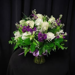 White and purple mixed bouquet in a glass vase