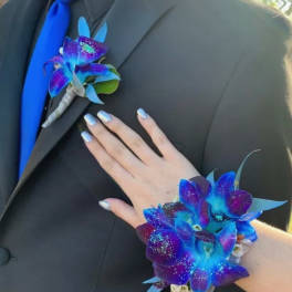 Boutonniere and wrist corsage with vivid blue and purple orchids