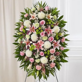 Standing funeral spray with pink lilies, roses, and white mums