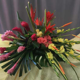 Tropical floral arrangement with pink, red, and yellow blooms