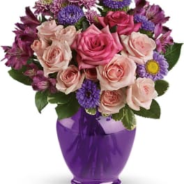 Pink roses and purple daisies in a purple vase