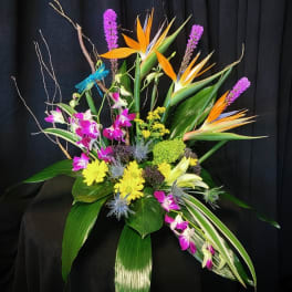 Tropical floral arrangement with orchids and bird-of-paradise flowers