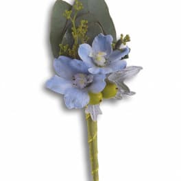 Blue flower boutonniere with green leaves and wrapped stem