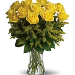 Yellow roses arranged in a clear glass vase