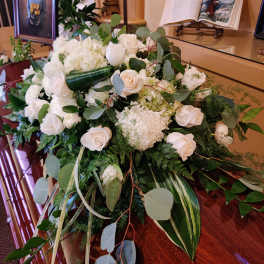 White floral casket spray with roses and hydrangea