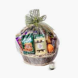 Gift basket with snacks and a small candle
