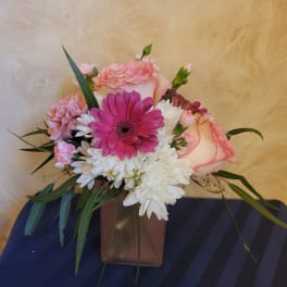 Pink and white mixed bouquet in a brown vase