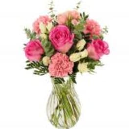 Pink and peach bouquet in a clear glass vase