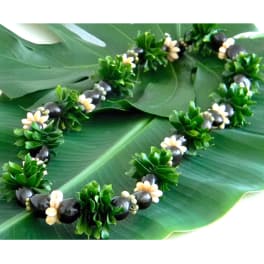 Green leaf lei with small white flowers and dark beads