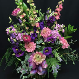 Purple and pink mixed bouquet with eucalyptus in a vase