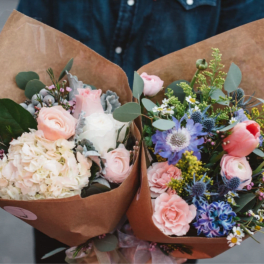 Two wrapped bouquets with pastel flowers and mixed blooms