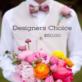 Person holding a colorful bouquet with a boutonniere on a white shirt