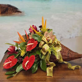 Tropical bouquet with red anthuriums and orange bird-of-paradise in a wicker cone
