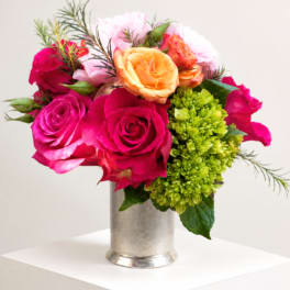 Bright pink and peach roses in a silver vase