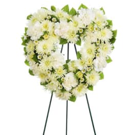 White floral funeral wreath on a standing easel