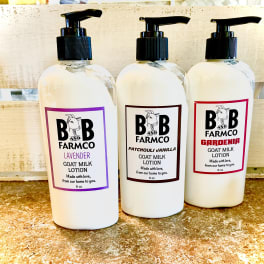 Three bottles of goat milk lotion with pump tops