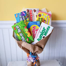 Bouquet of assorted candy boxes wrapped in brown paper