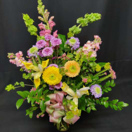 Mixed bouquet with yellow lilies, purple mums, and pink flowers