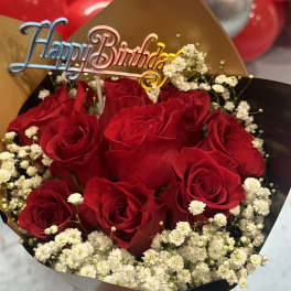 Bouquet of red roses with white baby's breath and a Happy Birthday topper