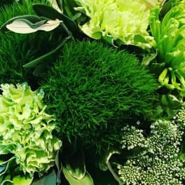 Green floral arrangement with white calla lilies and pale green blooms